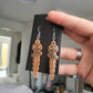 UV Active Glow Orange Wavy Dagger Resin Earrings