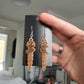 UV Active Glow Orange Wavy Dagger Resin Earrings
