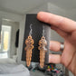 UV Active Glow Orange Wavy Dagger Resin Earrings