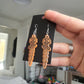 UV Active Glow Orange Wavy Dagger Resin Earrings